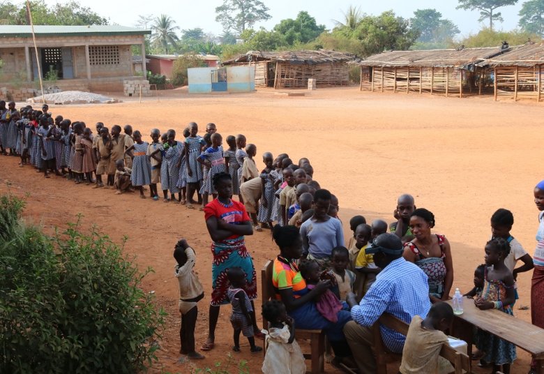 Finding trachoma Credit: Kramoko Bamba / Sightsavers Caption "In Amédékro, Ivory Coast, Children wait in an orderly queue for Dr Sarr Boubacar to screen them for trachoma. He checks the eyes of all of the children for evidence of this potentially blinding neglected tropical disease, which typically affects people in remote or poor areas.  During this activity, almost 2000 children were screened and those with trachoma were given medication to treat the infection.  Importantly, he also trained others in the 