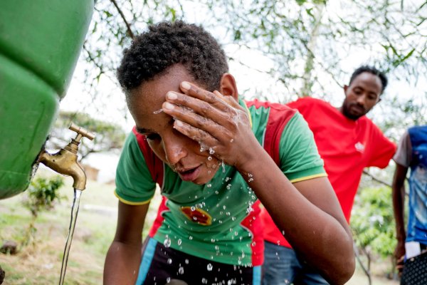 Misganaw Worku, 15, a student leader in the CBM-supported anti-trachoma club at Double Mariam Primary School, washes his face in Double Mariam, Amhara Region, Ethiopia. CBM/Hayduk